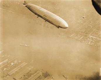 (DIRIGIBLES) A group of 11 photographs depicting dirigibles in air or parked in giant hangers, primarily American vessels.